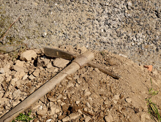Work tool: pickaxe resting on the ground