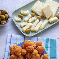 Balkan cuisine. Local cheese, olives and priganice  (small fried cakes, donuts) on rustic table