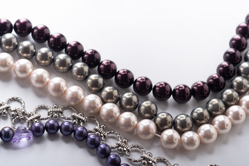 different colors pearls beads pesented together against white background. fashion and jewelry concept