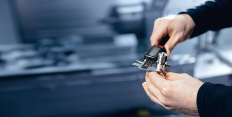 Industry Engineer working with metal detail after CNC machine turning cutting iron