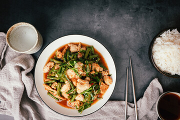 Top view,  Stir-fried pork and red hot curry paste with or long bean and Ingredients are oyster sauce, fish sauce, sugar, kaffir lime leaves in the dish Eat with cooked rice. Thai food