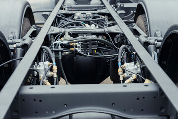 Underneath View of a Semi Truck or Trailer Rear Axle with the Suspension, Brake Cylinder Pod pneumatic system Close up View. Mud truck chassis frame suspension with wheel and arms with silent blocks