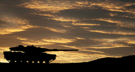 Fototapeta na wymiar Silhouette of army tank at sunset sky background. Military machinery.