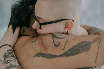 close up of queer couple embracing 
