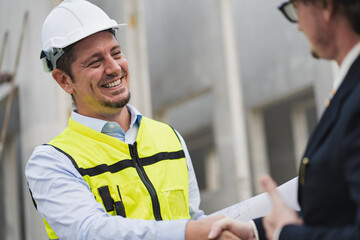 Happy caucasian engineer man check hand with manager in precast site work 