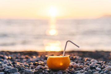 Citrus fruit with paper tube on sunset background