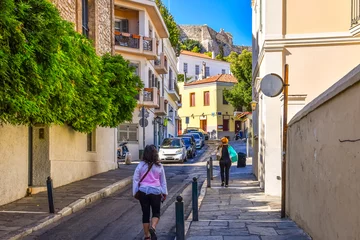 Gardinen Local Athenians walk through a residential area of the Plaka district under the Acropolis Hill in Athens, Greece. © Kirk Fisher