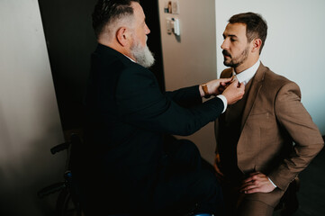 Father and son on their wedding day getting ready
