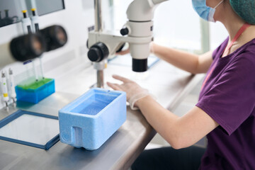 Female geneticist prepares a biomaterial for vitrification