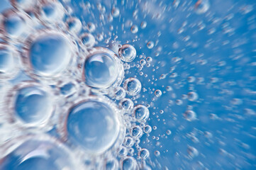 Water close up. Movement of water with oxygen bubbles. Blue beautiful underwater background