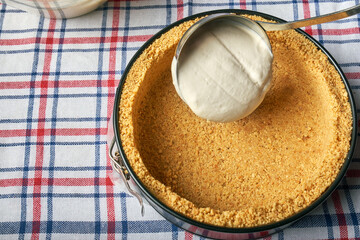 ladle with dough over the form for cheesecake, top view