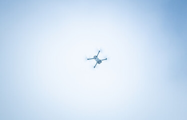 Flying gray drone in the sky.
