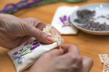 Making lavender aromatherapy sachet with floral embroidery at home. Zero waste DIY gift. Photo with selective focus