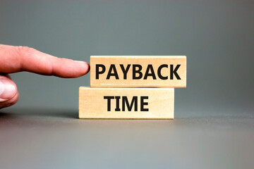 Payback time symbol. Concept words Payback time on wooden blocks. Beautiful grey table grey...