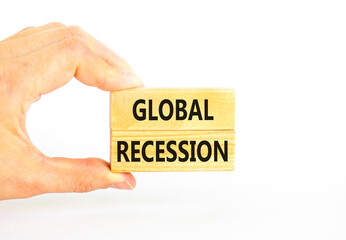 Global recession symbol. Concept words Global recession on wooden blocks. Beautiful white table white background. Businessman hand. Business and global recession concept. Copy space.