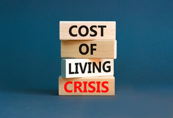 Cost of living crisis symbol. Concept words Cost of living crisis on wooden blocks. Beautiful grey table grey background. Business cost of living crisis concept. Copy space.