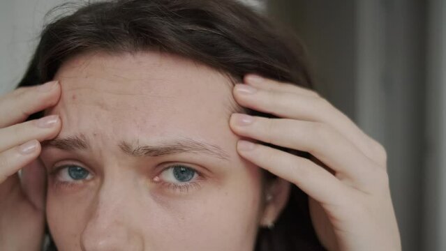 Problem Skin. Close up of sad woman touching acne and wrinkles on her face. Skin care
