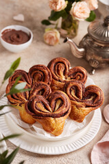 Buns in a shape of hearts made from yeast dough with chocolate filling. Valentine day dessert.