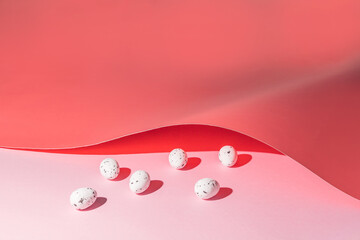 Easter eggs under a pink paper cover. Minimal Easter holiday concept
