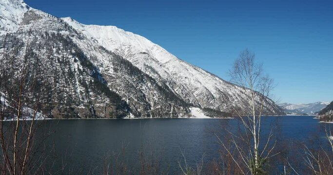 Achensee in der Gemeinde Eben am Achensee in Tirol. Blick vom Pertisauer Ufer. Sein ruhiges Wasser am Fu&szlig;e der schneebedeckten Berge