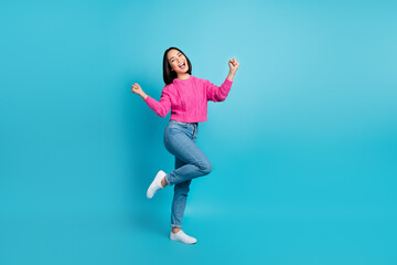 Fototapeta na wymiar Full size photo of overjoyed satisfied girl raise fists triumph luck empty space isolated on blue color background