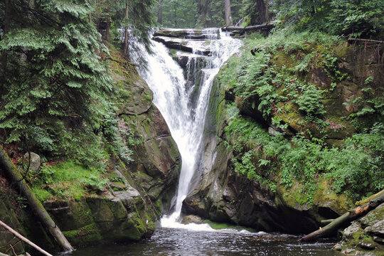 Szklarka Waterfall, the waterfall in the Polish part of The Karkonosze Mountains falling from a rocky wall in the forest
