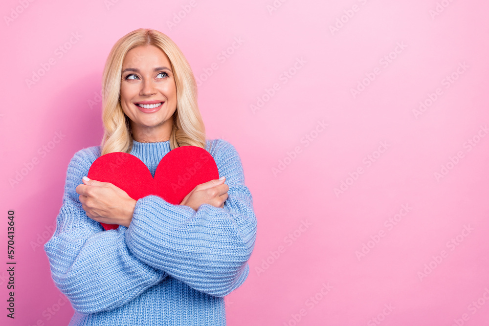 Sticker photo of dreamy cute positive lady hand hold red paper card interested look empty space isolated on 