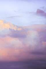 Sky with soft and fluffy pastel lilac pink and blue colored clouds. Sunset background. Nature. sunrise. Instagram toned style. Vertical
