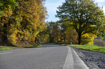 Road with blurred background nature, trees and car