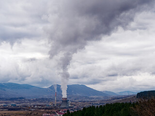 Thermal power station expelling pollutants to the air. City with poor air quality due to thermal...
