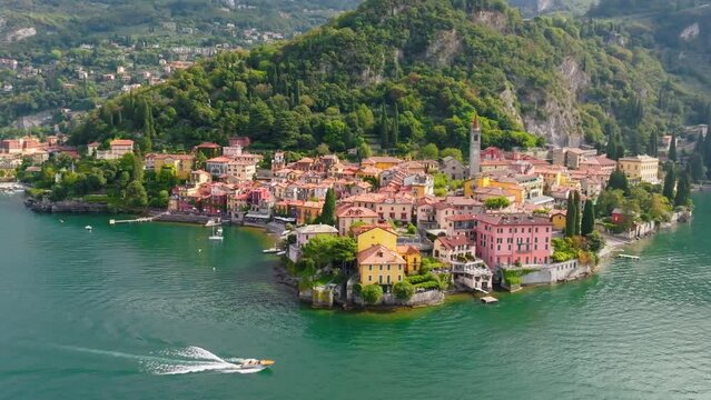 Aerial view of Varenna, Lake Como, Italy. Flying over orange roofs of old town with the church of San Giorgio in the central square