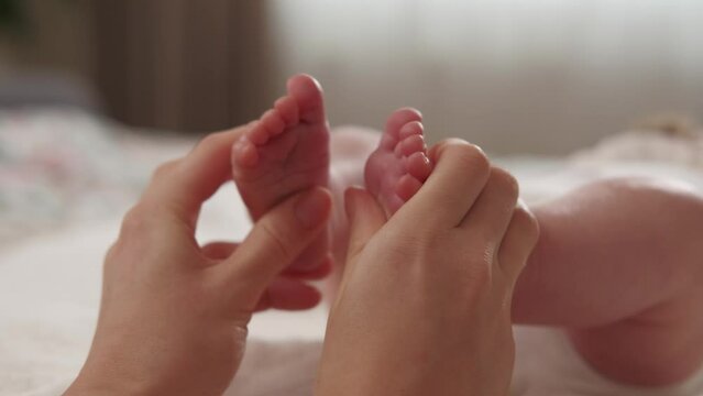 Close up video of Mother making massage to baby foot.