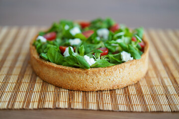 Cake of vegetables lying on the wooden background. Healthy cooking concept