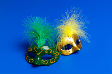 Multicolored carnival mask on blue background. Purim.