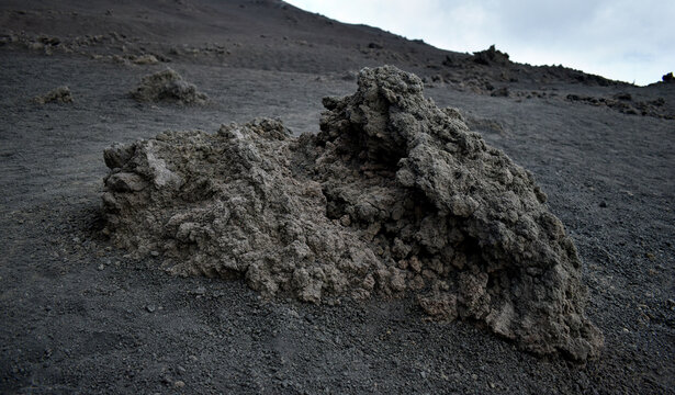 Volcanic slag, grey coloured lava on the volcanic bedrock of Mount Etna volcano, Sicily, Italy