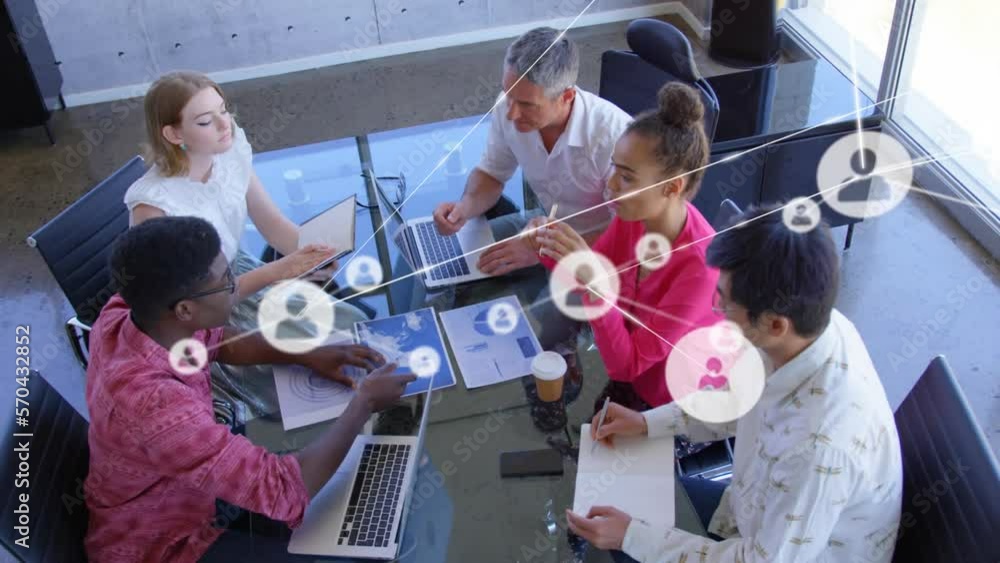 Aufkleber animation of network of icons against overhead view of diverse colleagues discussing at office
