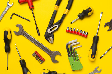 Set of tools on color background, top view