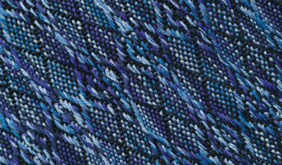 Handwoven fabric in black and blue shades with complicated pattern.