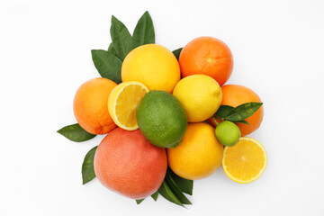 Different citrus fruits and leaves on white background, top view