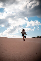 African girl walking with scarf in the wind