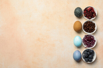 Painted Easter eggs with natural organic dyes (hibiscus, coffee beans, beetroot and blueberries) on light table, flat lay. Space for text