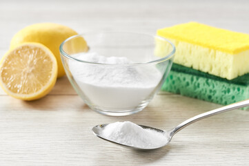 non-toxic cleaner, baking soda and lemon on a white kitchen table.