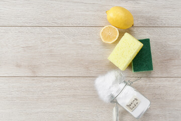 non-toxic cleaner, baking soda and lemon on a white kitchen table, top view.