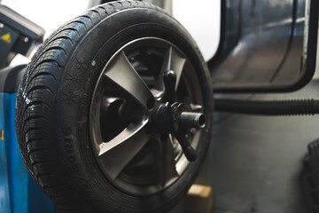 Obraz na płótnie Canvas Balancing the wheel in car service, car repair concept. High quality photo