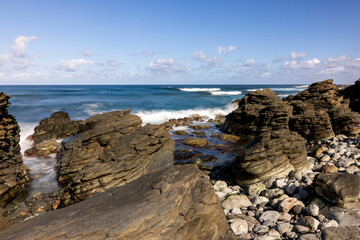 Nature's Fury: The Ocean's Power on Display at Daylight with Clouds Above