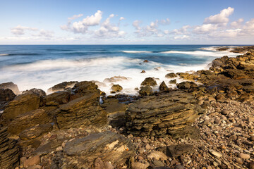 Nature's Fury: The Ocean's Power on Display at Daylight with Clouds Above