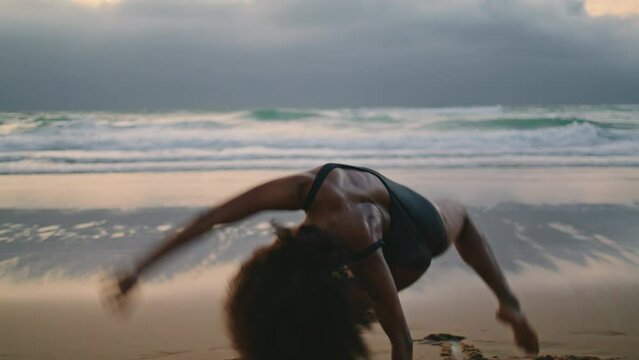Girl seductive dance beach at cloudy evening. Woman dancing contemporary dance.