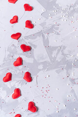 Valentine's Day background. Red hearts on concrete gray background. Valentines day concept. Flat lay, top view, copyspace