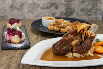 Full feast of the table with the roasted lamb shank featured up front to satisfy any appetite
