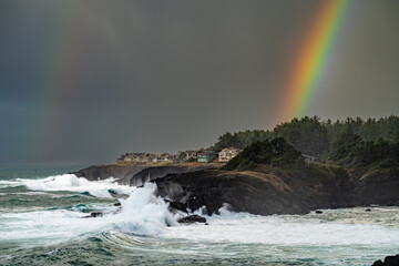 Huge waves during a King tide with a rainbow near Depoe Bay Oregon coast